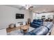 Cozy living room with hardwood floors, a plush rug, and a large, comfortable blue leather couch at 5525 Sable Way, Atlanta, GA 30349