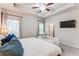 Comfortable main bedroom featuring tray ceiling, ceiling fan, large bed and a wall-mounted TV at 5525 Sable Way, Atlanta, GA 30349