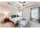 Spacious main bedroom featuring tray ceiling, ceiling fan, large bed, and natural light at 5525 Sable Way, Atlanta, GA 30349