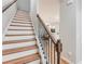 Elegant staircase featuring hardwood steps, white risers, and a dark wood railing at 5525 Sable Way, Atlanta, GA 30349