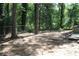 View of a wooded backyard with a chainlink fence and space for outdoor activities at 5561 Petite Pt, Lithonia, GA 30058