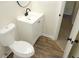 This bathroom features a clean vanity, toilet, and modern fixtures on wood-look flooring at 5561 Petite Pt, Lithonia, GA 30058