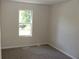The bedroom offers neutral paint, carpeted floors, and a window to the backyard at 5561 Petite Pt, Lithonia, GA 30058