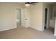 Spacious bedroom with modern ceiling fan, and neutral decor with an ensuite bathroom at 5561 Petite Pt, Lithonia, GA 30058