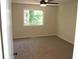 Bright bedroom featuring neutral walls, carpet flooring, and natural light from the window at 5561 Petite Pt, Lithonia, GA 30058