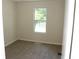 Bright bedroom featuring neutral walls, carpet flooring, and natural light from the window at 5561 Petite Pt, Lithonia, GA 30058