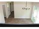 Bright dining room with new floors, modern light fixture, and sliding door to the backyard at 5561 Petite Pt, Lithonia, GA 30058