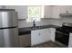 Modern kitchen with stainless steel appliances, new countertops, and white cabinets at 5561 Petite Pt, Lithonia, GA 30058