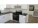 Updated kitchen featuring white cabinets, granite countertops, and stainless steel appliances at 5561 Petite Pt, Lithonia, GA 30058
