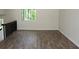 Open-concept room featuring wood floors, large window and neutral walls at 5561 Petite Pt, Lithonia, GA 30058