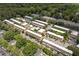 An aerial view of a residential area with a community pool and ample parking surrounded by lush greenery and trees at 6980 Roswell Rd # B13, Sandy Springs, GA 30328