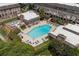 Aerial view of a community pool area, showcasing the amenities, landscaping, and surrounding townhomes at 6980 Roswell Rd # B13, Sandy Springs, GA 30328