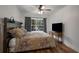 Bedroom with decorative wood headboard, ceiling fan, and natural light at 6980 Roswell Rd # B13, Sandy Springs, GA 30328