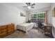 Bedroom featuring a large window, desk, dresser and neutral colors at 6980 Roswell Rd # B13, Sandy Springs, GA 30328