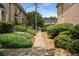 Charming walkway lined with lush greenery, leading to well-maintained townhomes in a quiet neighborhood at 6980 Roswell Rd # B13, Sandy Springs, GA 30328
