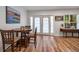 Bright dining area features a wood table, wood floors, and French doors to a patio at 6980 Roswell Rd # B13, Sandy Springs, GA 30328