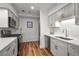 Bright kitchen features stainless steel appliances, white cabinets, and wood floors at 6980 Roswell Rd # B13, Sandy Springs, GA 30328