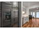Modern kitchen with stainless steel refrigerator and appliances, open to the dining area at 6980 Roswell Rd # B13, Sandy Springs, GA 30328
