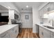 Well-lit kitchen features modern stainless steel appliances, white cabinets, and wood floors at 6980 Roswell Rd # B13, Sandy Springs, GA 30328