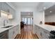 Bright kitchen with stainless steel appliances, white cabinets, and access to the dining room at 6980 Roswell Rd # B13, Sandy Springs, GA 30328