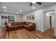 Inviting living room featuring a large L-shaped sofa, hardwood floors, and ample lighting at 6980 Roswell Rd # B13, Sandy Springs, GA 30328