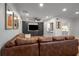 Open concept living area with hardwood floors, a view to the kitchen, and a large comfortable sectional sofa at 6980 Roswell Rd # B13, Sandy Springs, GA 30328