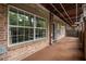Spacious outdoor patio with brick flooring and a partially covered ceiling, ideal for enjoying the outdoors at 6980 Roswell Rd # B13, Sandy Springs, GA 30328