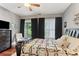 Well-lit bedroom with a unique bed frame, colorful quilt, and access to a balcony through french doors at 205 3Rd Street Northeast Ne St # 4, Atlanta, GA 30308