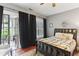 Bright bedroom with hardwood floors, decorative quilt, and french doors leading to outdoor balcony at 205 3Rd Street Northeast Ne St # 4, Atlanta, GA 30308