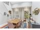 Bright dining room features a wooden table with seating for six, blue rug, and french doors to the porch at 205 3Rd Street Northeast Ne St # 4, Atlanta, GA 30308