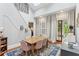 Bright dining room features a wooden table with seating for six, blue rug, and french doors to the porch at 205 3Rd Street Northeast Ne St # 4, Atlanta, GA 30308
