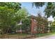 Charming multi-story brick home with manicured lawn, trees, and iron fencing at 205 3Rd Street Northeast Ne St # 4, Atlanta, GA 30308