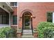 Inviting brick facade with arched doorway and classic black iron railings at 205 3Rd Street Northeast Ne St # 4, Atlanta, GA 30308