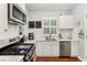 Well-lit kitchen featuring stainless steel appliances, white cabinets, subway tile backsplash, and hardwood floors at 205 3Rd Street Northeast Ne St # 4, Atlanta, GA 30308