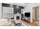 Cozy living room with fireplace, plantation shutters, and beautiful accent wall at 205 3Rd Street Northeast Ne St # 4, Atlanta, GA 30308