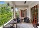 Inviting outdoor porch with wicker furniture, blue cushions, ceiling fan, and view of the surrounding greenery at 205 3Rd Street Northeast Ne St # 4, Atlanta, GA 30308