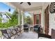 Inviting outdoor porch with wicker furniture, blue cushions, ceiling fan, and view of the surrounding greenery at 205 3Rd Street Northeast Ne St # 4, Atlanta, GA 30308