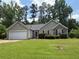 Charming single-story home featuring a well-manicured lawn and an attached two-car garage at 3505 Saddle Creek Ln, Ellenwood, GA 30294