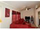 Inviting living room with a large red sectional sofa, media center, and decor at 3505 Saddle Creek Ln, Ellenwood, GA 30294