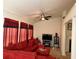 Comfortable living room with a large red sectional sofa and a ceiling fan for added comfort at 3505 Saddle Creek Ln, Ellenwood, GA 30294