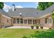 Expansive backyard showing a patio, well maintained lawn and brick home exterior at 997 Thousand Oaks Nw Bnd, Kennesaw, GA 30152