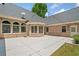 Large concrete patio with brick home exterior and a view of the backyard at 997 Thousand Oaks Nw Bnd, Kennesaw, GA 30152