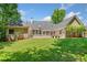 Spacious backyard featuring lush green lawn and a brick home exterior at 997 Thousand Oaks Nw Bnd, Kennesaw, GA 30152