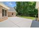Brick home with large concrete patio area and mature trees for shade at 997 Thousand Oaks Nw Bnd, Kennesaw, GA 30152