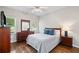 Bedroom with wood floors, neutral walls, and a dresser with a mirror at 997 Thousand Oaks Nw Bnd, Kennesaw, GA 30152