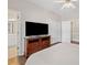 Bedroom with wood floors, TV, ceiling fan and view to the bathroom at 997 Thousand Oaks Nw Bnd, Kennesaw, GA 30152