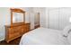 Bright bedroom featuring hardwood floors, a large dresser, and a closet at 997 Thousand Oaks Nw Bnd, Kennesaw, GA 30152