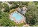 A refreshing community pool with lounge chairs, surrounded by mature trees in a neighborhood setting at 997 Thousand Oaks Nw Bnd, Kennesaw, GA 30152