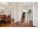 Elegant dining room with hardwood floors, wainscoting, and an open view to the living room at 997 Thousand Oaks Nw Bnd, Kennesaw, GA 30152