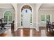 Grand foyer with arched entryway, hardwood floors, and natural light streaming through large windows at 997 Thousand Oaks Nw Bnd, Kennesaw, GA 30152